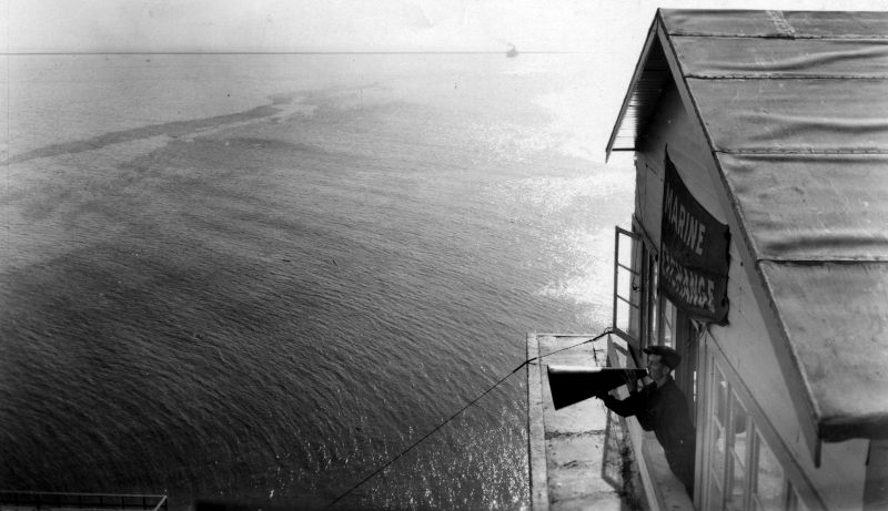 A man speaking through a megaphone circa 1923